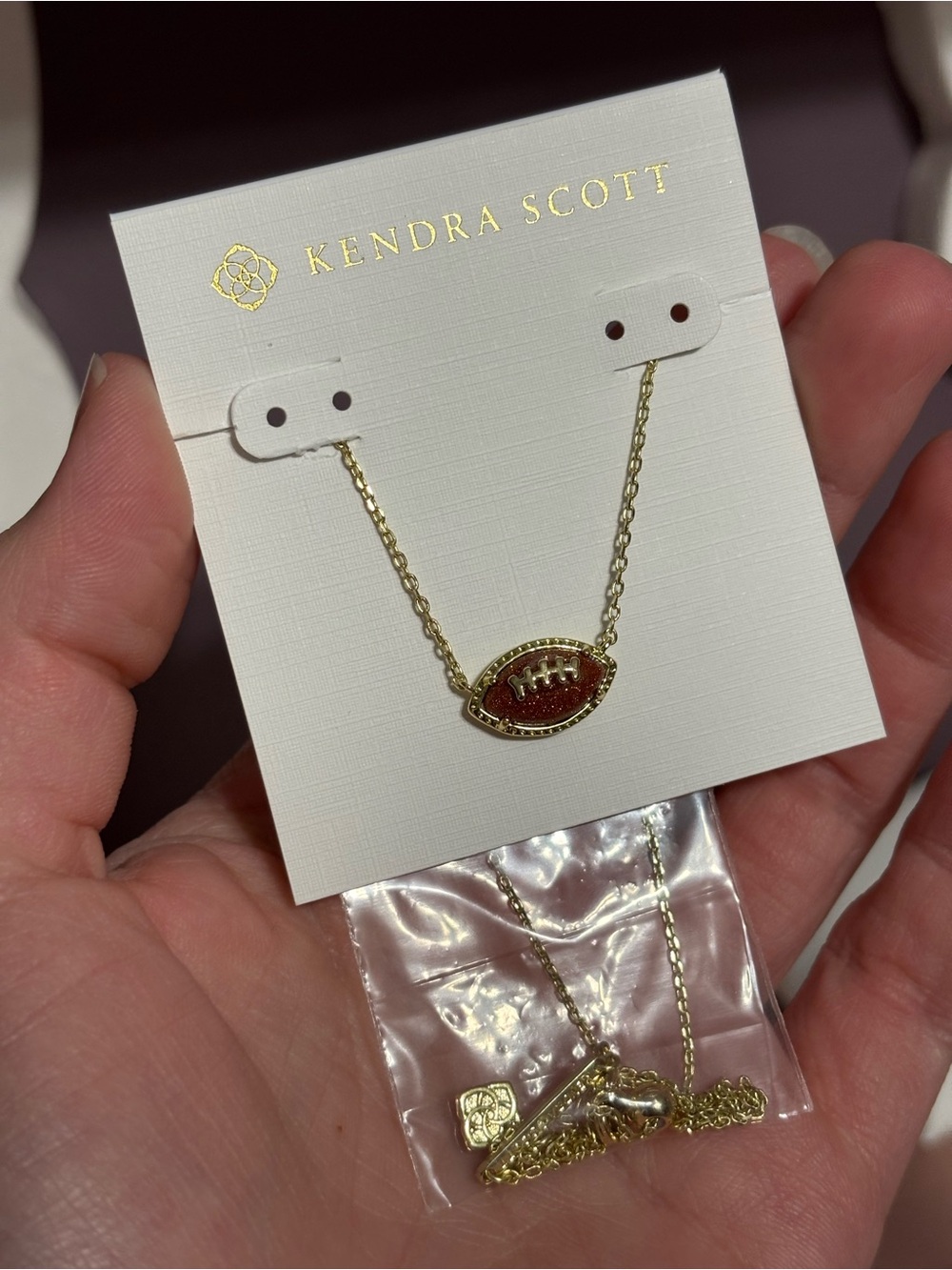Kendra Scott Gold Necklace with Brown Glitter Football Pendant - Picture 2 of 3
